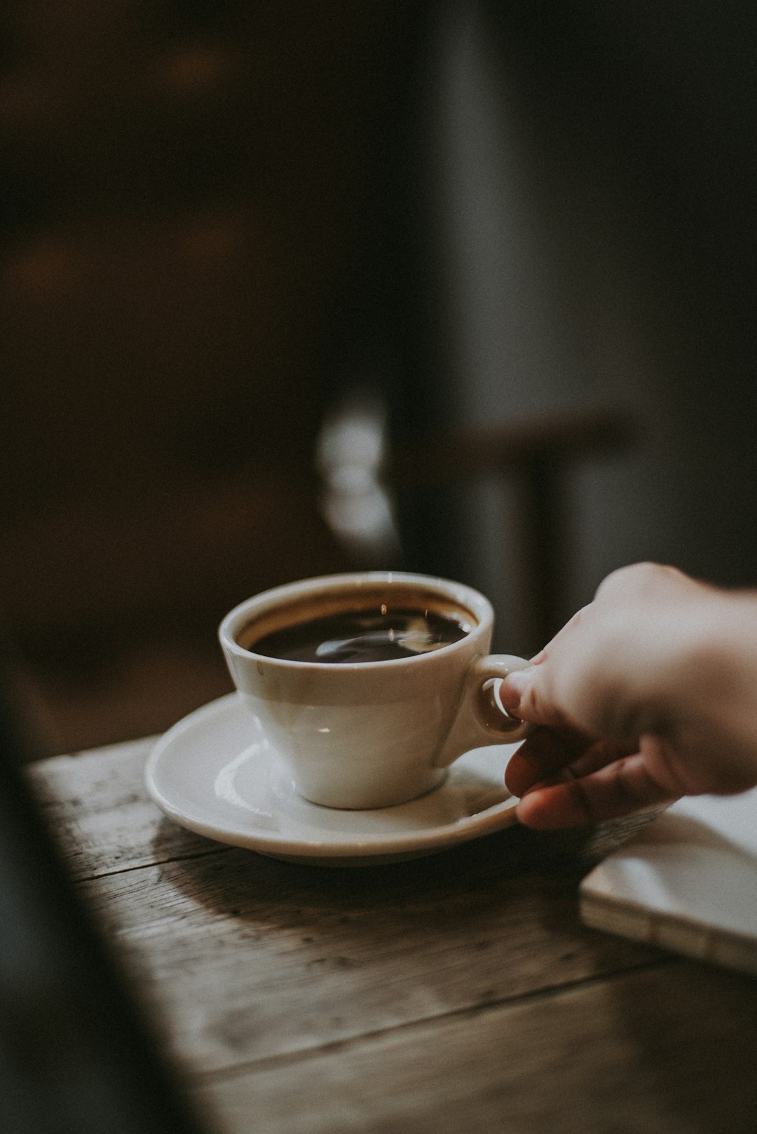 Photo by SnapbyThree MY person holding white ceramic cup with liquid